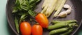 Organic fresh vegetables courgette, tomato, asparagus, basil, dill, green peas, garlic in a frying pan Royalty Free Stock Photo