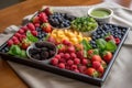 organic fruit tray with mixed berries and greens Royalty Free Stock Photo