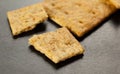 Organic grain crackers on black, selective focus. Close-up