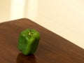 fresh organic green capsicum on a wooden table