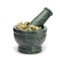 Organic Green cardamom (Elettaria cardamomum) on marble pestle.