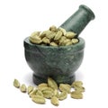 Organic Green cardamom (Elettaria cardamomum) on marble pestle.