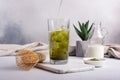 Organic green matcha ice tea or latte in trendy glass with bamboo whisk Royalty Free Stock Photo