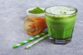 Organic green matcha tea latte in glass and powder in white bowl with bamboo whisk Royalty Free Stock Photo