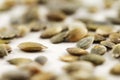 Organic green pumpkin seeds against a white background