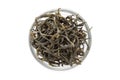 Organic Green Tea (Camellia sinensis) dried long leaves in glass bowl.