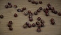 Organic hazelnut falling on wooden background. Slow motion.