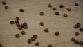 Organic Hazelnuts kernel falling on wooden background. Slow motion.
