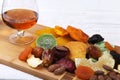 Organic Healthy Assorted Dried Fruit and glasses with cognac or whiskey on wine board. Selective focus. Royalty Free Stock Photo