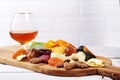 Organic Healthy Assorted Dried Fruit and glasses with cognac or whiskey on wine board. Selective focus. Royalty Free Stock Photo