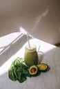 Organic and healthy green smoothie with banana, spinach, avocado, citrus fruits and chia seeds in a glass bottles on a rustic Royalty Free Stock Photo