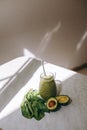 Organic and healthy green smoothie with banana, spinach, avocado, citrus fruits and chia seeds in a glass bottles on a rustic Royalty Free Stock Photo