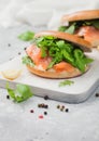 Organic healthy sandwiches with salmon and bagel, cream cheese and wild rocket and lemon