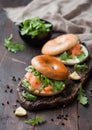 Organic healthy sandwiches with salmon and bagel, cream cheese and wild rocket and lemon Royalty Free Stock Photo