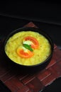 Organic healthy yellow khichdi on black background