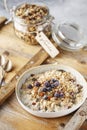 Organic homemade granola cereal with oats, nuts and dried berries. Muesli in a glass jar. Healthy vegan breakfast or snack. Copy Royalty Free Stock Photo