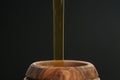 Organic honey pour into wooden pot