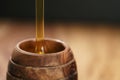 Organic honey pour into wooden pot