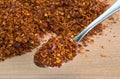 Organic Hot Red Chili Flakes on wooden cutting board Royalty Free Stock Photo