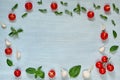 Organic ingredients for salad: sliced cherry tomatoes, fresh basil leaves, garlic on the gray background with copy space for text Royalty Free Stock Photo