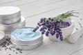 Organic lavender cream, mortar and bunch of dry lavender flowers on white wooden table Royalty Free Stock Photo