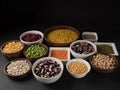 Organic legumes. Black background. Different varieties of peas, beans and lentils. Royalty Free Stock Photo