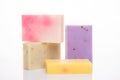 Organic lemon orange coffee herbs aloe soap bars concept. Photo of variety of homemade colorful soap bars isolated on white