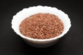 Organic Linseed or Flaxseed in ceramic bowl. Royalty Free Stock Photo