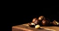 Organic macadamia nut on a wooden table on a dark background. Place for text