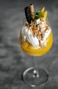 Mango and passion fruit tropical ice cream sundae in glass