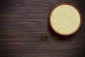 Organic millet in bowl on wooden table