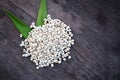 Organic millet grains on old wooden table background, top view