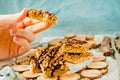 Organic Muesli and Dried fruit bars. Healthy breakfast and snack. White and blue table background. The process of eating. In the Royalty Free Stock Photo