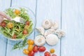 Organic mushrooms. Health food. Fresh mushrooms and arugula salad, cherry tomatoes Royalty Free Stock Photo