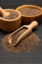 Organic natural chia seeds, bowl and wooden scoop close-up on wooden background or table Royalty Free Stock Photo