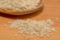 Organic natural sesame seeds on wooden spoon, healthy food background