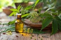 Organic neem oil with leaves and flowers on wooden surface Royalty Free Stock Photo