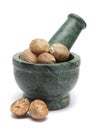 Organic Nutmeg Seed or Jaiphal (Myristica fragrans) on marble pestle. Royalty Free Stock Photo