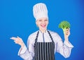 Organic nutrition. Woman chef hold broccoli pointing at copy space. Healthy vegetarian recipes. Amazing broccoli facts