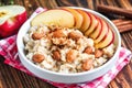 Organic oatmeal porridge in white ceramic bowl with apple, almond, honey and cinnamon. Healthy breakfast Royalty Free Stock Photo