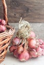 Organic onion in a basket on a wooden background Royalty Free Stock Photo