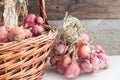 Organic onion in a basket on a wooden background Royalty Free Stock Photo