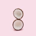 Organic opened two parts of the coconut head against a baby pink background at the top of each other. Fresh fruit, nut and seed Royalty Free Stock Photo