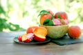 Organic peach on plate and in bowl on rustic table