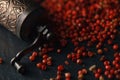 Organic Pink Peppercorn in wooden spoon on black slate stone bac Royalty Free Stock Photo