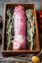 Organic pork fillet with ingredients and herbs for grill or baking, sage, potatoe, in wooden box, on gray stone background Royalty Free Stock Photo