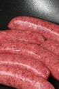 organic pork sausages in a pan Royalty Free Stock Photo