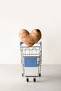 Organic potato in shape of heart flying into grocery cart