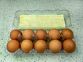 Ten brown chicken eggs in a egg box, close-up. Copy space Royalty Free Stock Photo