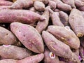 Organic Purple sweet potatoes in rows in fruit crate.